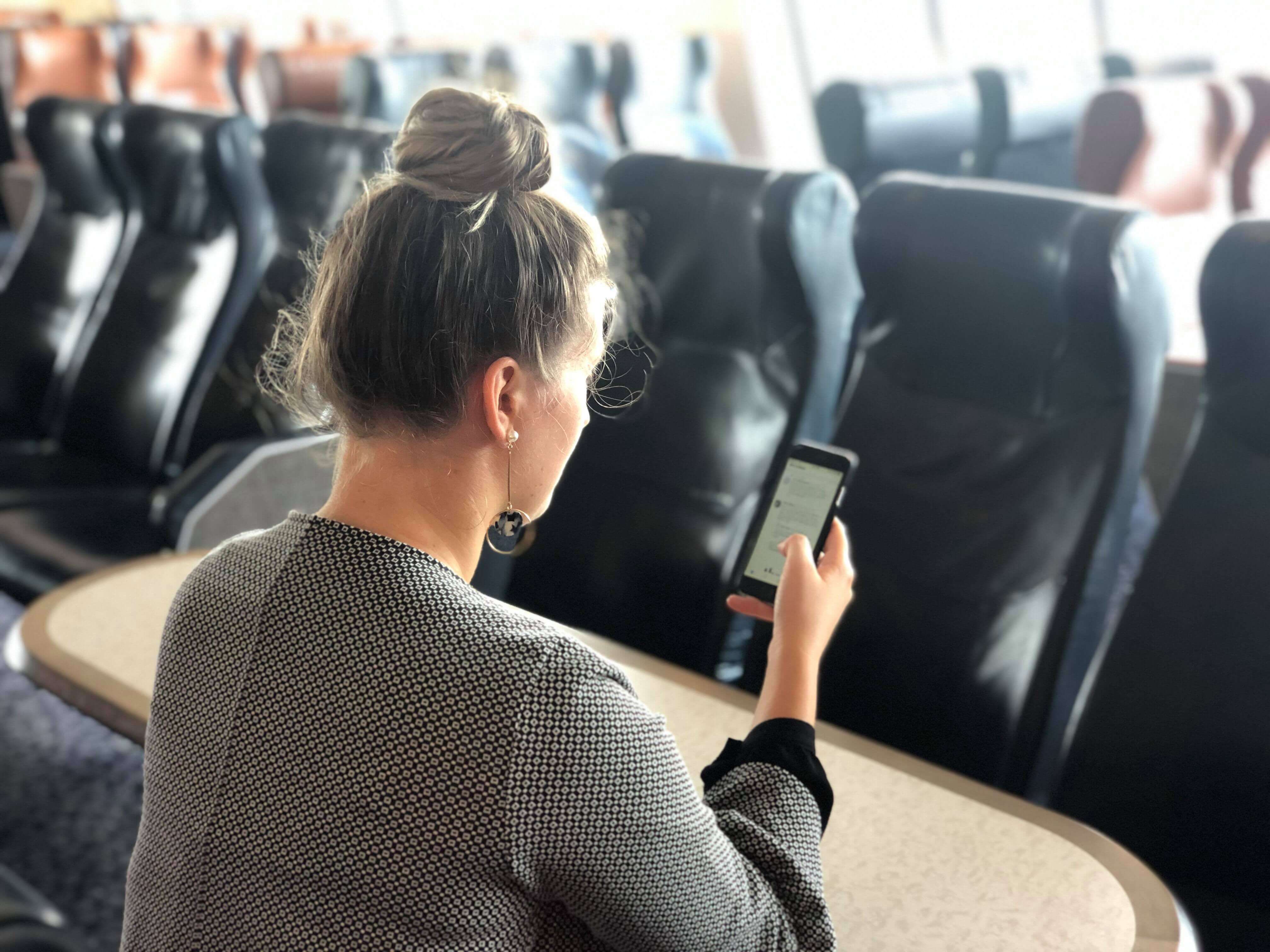 Customer using WiFi on her mobile on Bluebridge Ferry