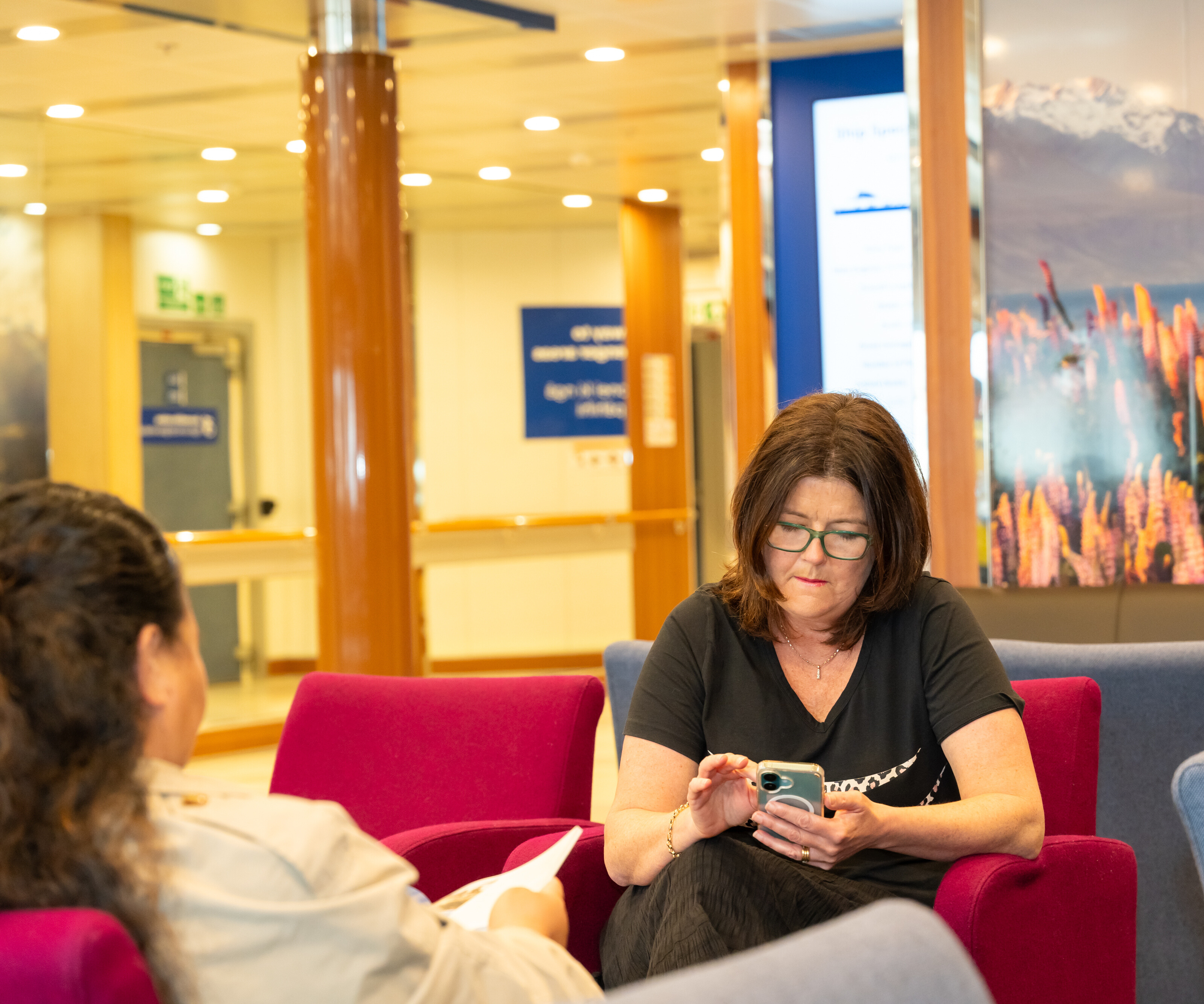 Customer using WiFi on her mobile on Bluebridge Ferry